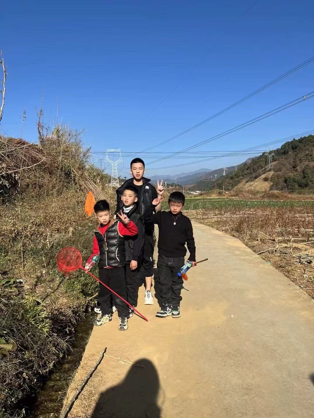 Children carrying nets on a village road